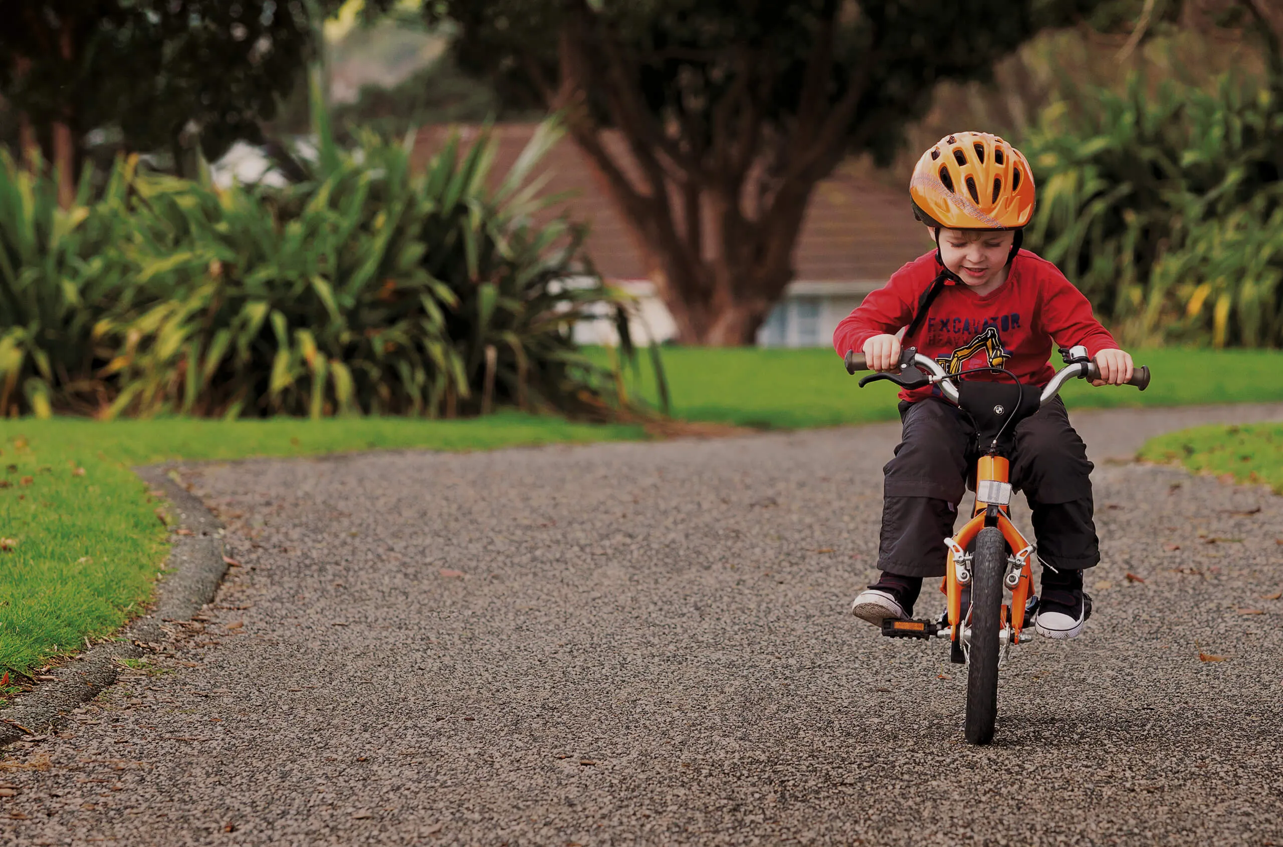 Young Boy Learning To Ride His Bike
